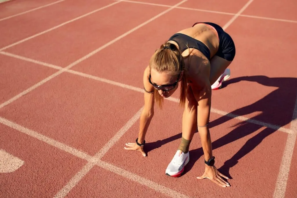 Woman athlete at the start of the treadmill. A start to a new life, the beginning of a new activity
